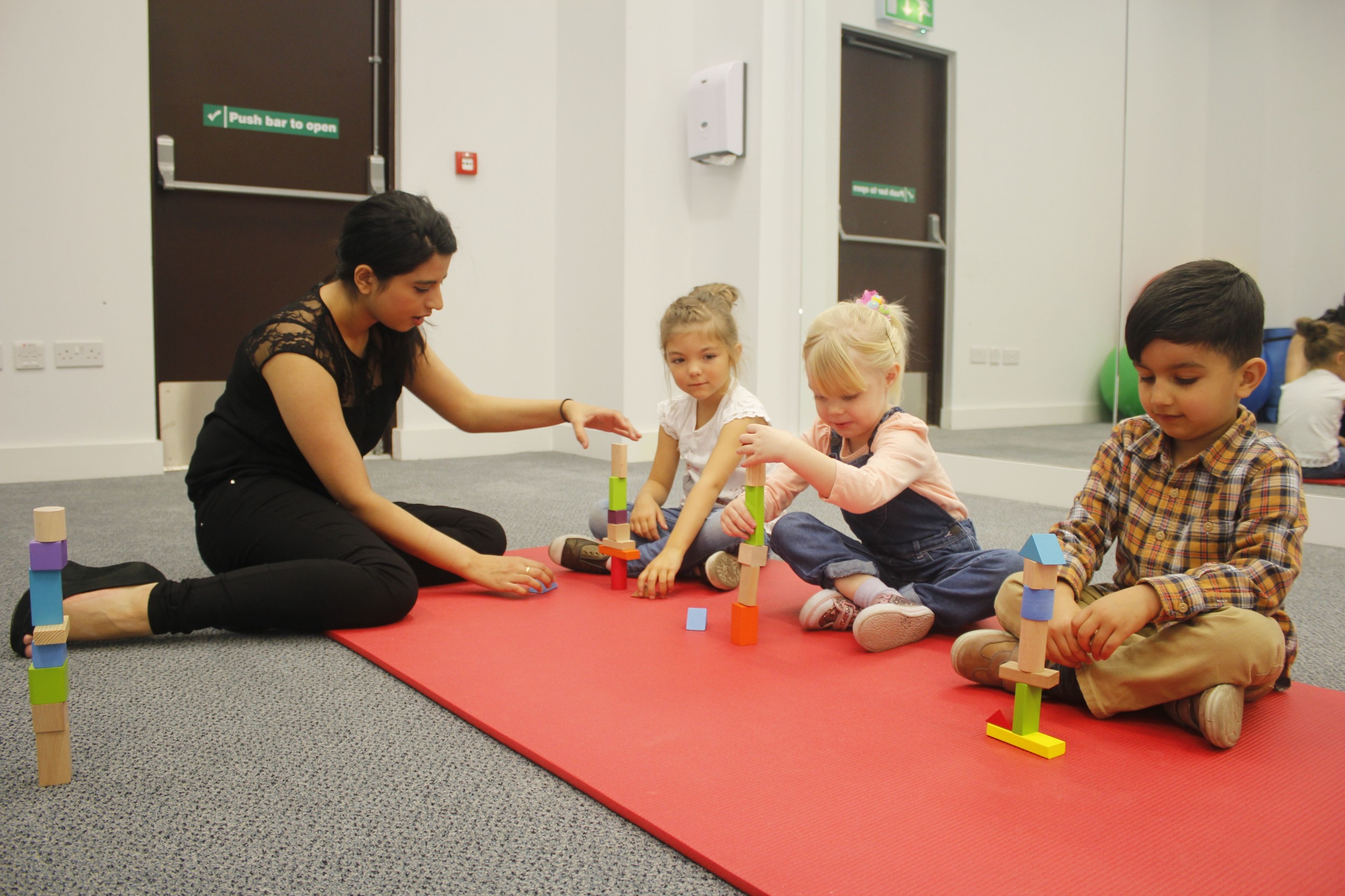 Saliha using construction activities to work on the child’s ability to switch between an activity and the adult.