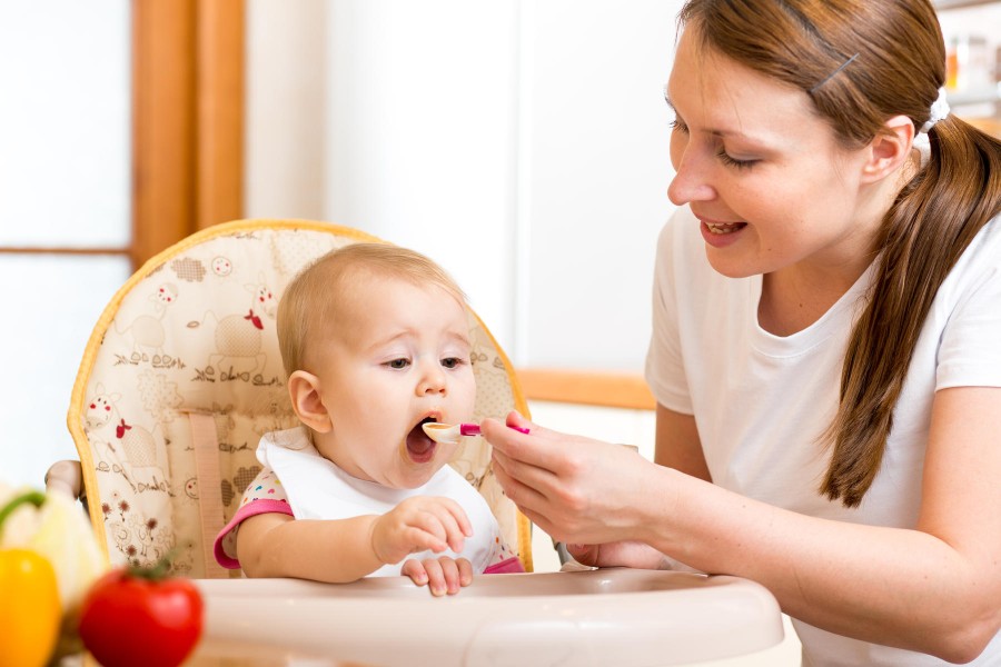 At five months babies will be able to take small amounts of pureed food from a spoon. At five months babies will be able to take small amounts of pureed food from a spoon.